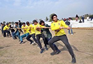 Students participate in the 100-meter race during the opening ceremony of the 'Reade Sports & Cultural Wave' event at the Tehsil Sports Complex