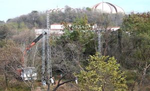 WAPDA workers busy in installing a new electric pole in Federal Capital.