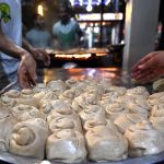 Vendors preparing traditional food stuff (Parathas) for Sehri to the customers at local market during Holy Fasting Month of Ramazan ul Mubarak