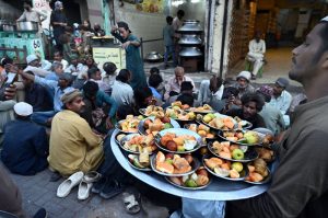 People gather for free Iftar at Pukka Fort Road during the holy month of Ramazan-ul-Mubarak.