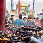 Devotees light oil lamps at shrine of Lal Shahbaz Qalandar on the occasion of 774th Urs celebration