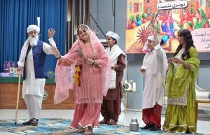 A student performs on stage during the Singing Competition (Folk & Ghazal) at Islamabad Model College for Girls (PG), G-10/4.