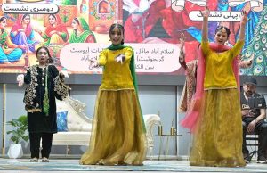 A student performs on stage during the Singing Competition (Folk & Ghazal) at Islamabad Model College for Girls (PG), G-10/4.