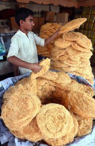 A vendor displays and sells freshly fried vermicelli (Pheni) ahead of Sehri and Iftar, attracting customers during the holy month of Ramazan at Bakrani Road.