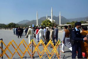 People undergo security checks before entering Faisal Masjid for the first Friday prayers of Ramazan ul Mubarak in the Federal Capital.