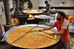Workers busy in frying traditional food Pakoriyaa mostly used in Dahi Bhalle during the holy fasting month of Ramazan