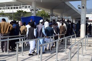 People undergo security checks before entering Faisal Masjid for the first Friday prayers of Ramazan ul Mubarak in the Federal Capital.