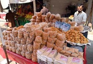 A vendor selling Iftar food items, including the popular Dehi Baray at the bustling Banni Chowk during the holy month of Ramazan.