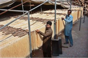 Workers dry vermicelli (sawian) under the sun to meet market demand at his workplace during the holy month of Ramazan.
