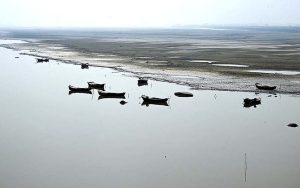 View of a boat parked on the bank of the Indus River near the Larkana-Khairpur Bridge.