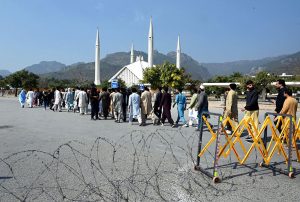 People undergo security checks before entering Faisal Masjid for the first Friday prayers of Ramazan ul Mubarak in the Federal Capital.