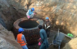 Workers are busy constructing a sewerage manhole.
