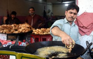 A vendor selling Iftar food items, including the popular Dehi Baray at the bustling Banni Chowk during the holy month of Ramazan.