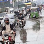 A motorcyclist carefully navigates through accumulated water during a light drizzle on Ferozepur Road in the provincial capital.