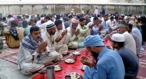 People offer prayers on the roadside before breaking their fast during the holy month of Ramadan.