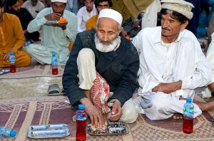A large number of people break their fast at a free Iftar point along the expressway near PWD in the holy month of Ramazan ul Mubarak.
