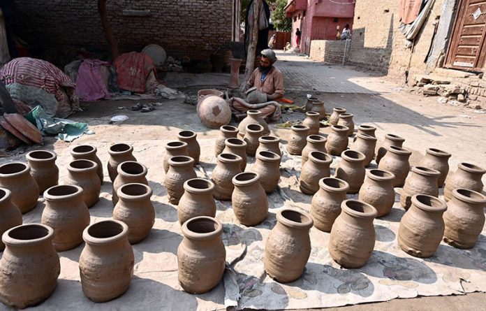 Worker busy preparing clay made stuff at his work place near Kumharpara
