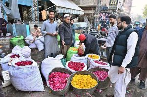 Vendor displaying flower petals to attract the customers in connection with Shab-e-Barat at flower market.
