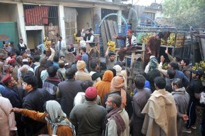 Vendors take part in a banana auction at a wholesale fruit market as traders bid for fresh produce during early morning trading hours.