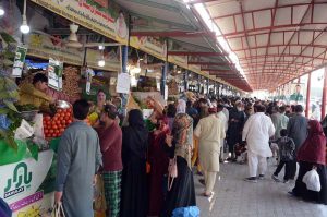 People purchase food items at a Sahulat Ramazan Bazaar during the holy fasting month Ramazan.