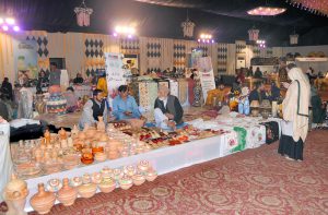 An artisan prepares colorful traditional baskets by hand at a stall during the 2nd day of annual 11th Blue Fair exhibition, organized by Women Chamber Of Commerce.
