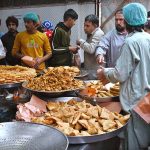 People busy purchasing traditional food items for iftari at Commercial Market during Holy Fasting Month of Ramazan