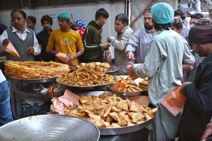 People busy purchasing traditional food items for iftari at Commercial Market during Holy Fasting Month of Ramazan