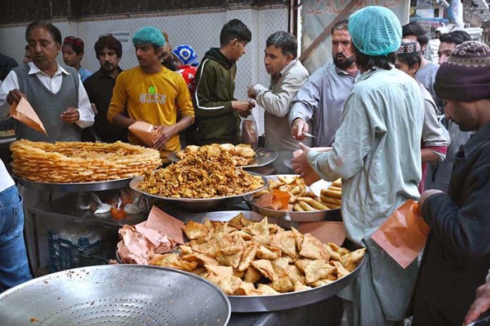 People busy purchasing traditional food items for iftari at Commercial Market during Holy Fasting Month of Ramazan