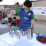 A volunteer preparing drinks for people during Iftar to break their fast in the Islamic month of Ramazan.