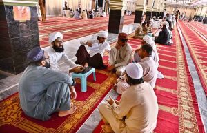 A teacher delivers religious teachings to students at Faizan-e-Madina Mosque during the holy month of Ramzan.