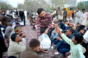 A large number of people from slum area receiving food to break their fast at a free Iftar reception by AWP in the holy month of Ramazan ul Mubarak.