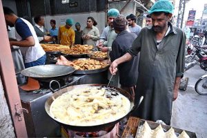 People busy purchasing traditional food items for iftari at Commercial Market during Holy Fasting Month of Ramazan