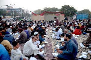 A large number of people from slum area receiving food to break their fast at a free Iftar reception by AWP in the holy month of Ramazan ul Mubarak.