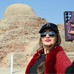 A woman takes a selfie while visiting the world-famous archaeological site of Moen-Jo-Daro as part of the Mohen-Jo-Daro Safari Train delegation by the Sindh Tourism Department