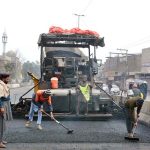 Heavy machinery being used during road construction work at Sheikhupura Road.