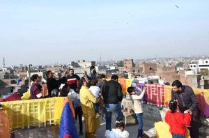 Women enjoys during celebrations of the three-day kite-flying festival “Basant”. The festival has returned to the provincial capital after 20 years