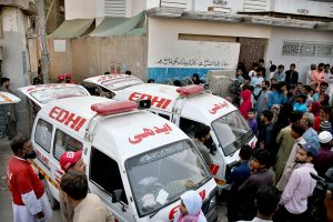 Rescue workers recover a body from the rubble of an apartment building following a gas explosion in Soldier Bazaar