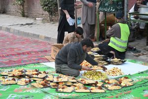 Volunteers arranging Iftar for common people to break their fast along the roadside in the holy month of Ramazan ul Mubarak