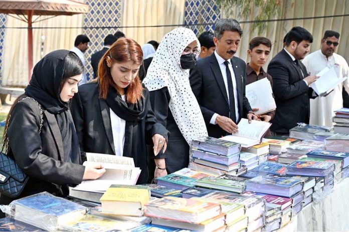 Lawyers viewing the displayed stuff at a books stall during Law Books Festival 2026 at District Court arranged by District Bar Association