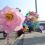vendor is displaying Colorful pinwheels along a roadside to attract customers