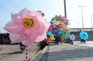 vendor is displaying Colorful pinwheels along a roadside to attract customers