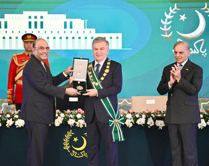 President Asif Ali Zardari confers the Nishan-e-Pakistan on the President of the Republic of Uzbekistan, Mirziyoyev Shavkat Miromonovich, during a Special Investiture Ceremony, in the presence of Prime Minister Muhammad Shehbaz Sharif, at Aiwan-e-Sadr