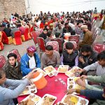 A large number of people having Iftar to break their fast at Chowk Allama Iqbal