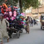 A labourer pulls a cart loaded with children's bicycles for supply to earn his livelihood during the holy month of Ramzan.