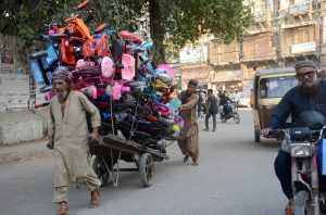 A labourer pulls a cart loaded with children's bicycles for supply to earn his livelihood during the holy month of Ramzan.