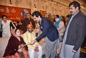 Newlywed couples offer prayers during a mass marriage ceremony at Paradise Marquee, Sheikhupura Road, where 111 couples tied the knot under the “Punjab Dhi Rani Program.”