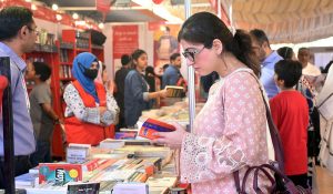 Women take keen interest in books at a stall during the 17th Karachi Literature Festival (KLF) at a local hotel.