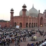 A large number of people wait for the Maghrib Azan before breaking their fast with iftar meals during the holy fasting month of Ramazan at the historical Badshahi Mosque in the provincial capital