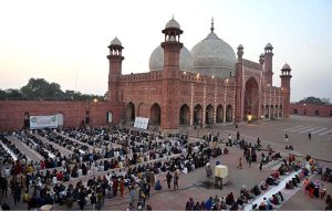 A large number of people wait for the Maghrib Azan before breaking their fast with iftar meals during the holy fasting month of Ramazan at the historical Badshahi Mosque in the provincial capital