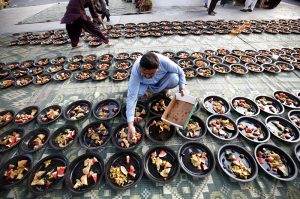 A man prepares Iftar meals for underprivileged people under Qayyumabad flyover